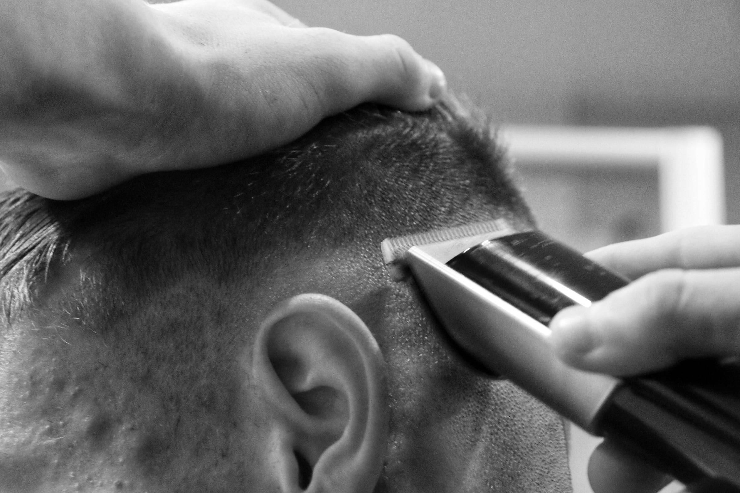 Trimmer zieht die Kontur über dem Ohr, Nahaufnahme